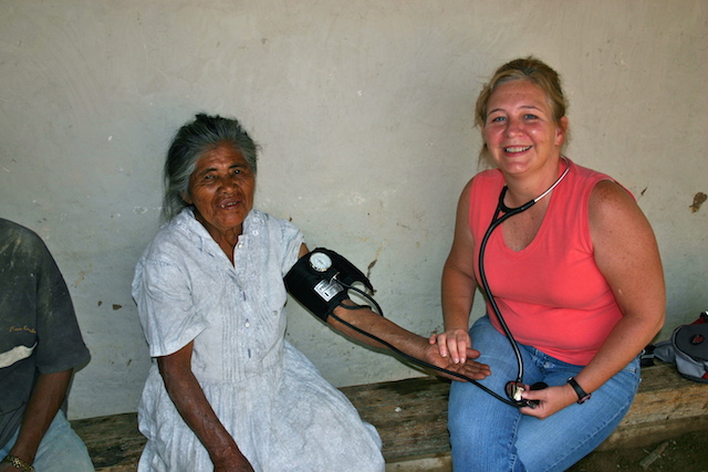 Gigi McMurray taking blood pressure of patient in Honduras